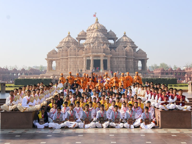 Group photo of participants with sadhus