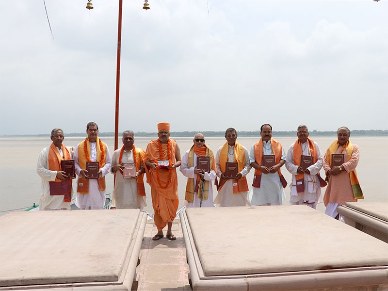 A group of distinguished scholars venerate the text at the holy banks of Ganga in Varanasi